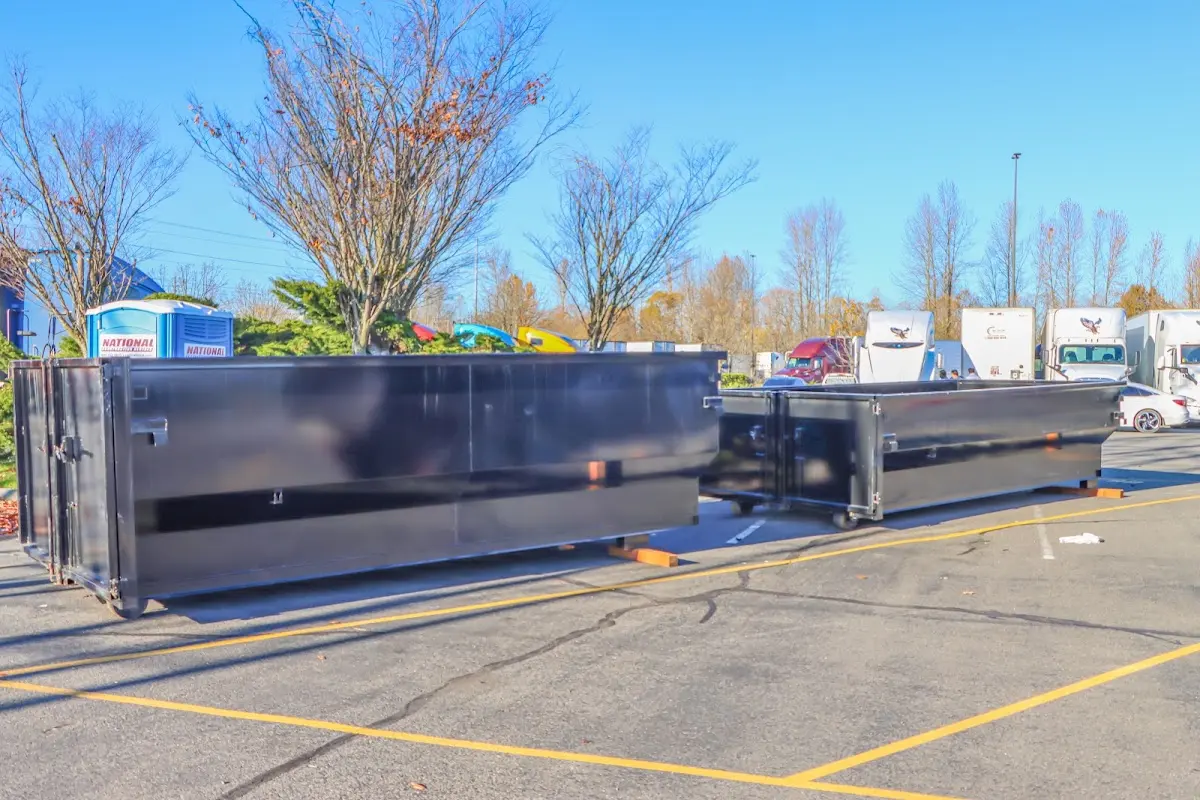 Professional dumpster rental service with roll-off container on residential driveway in Sonterra